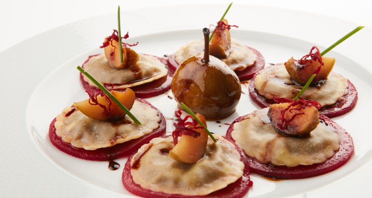 Ravioli mit Hirschpfeffer-Fühllung auf einem Carpaccio von Randen mit Büchelibirnen